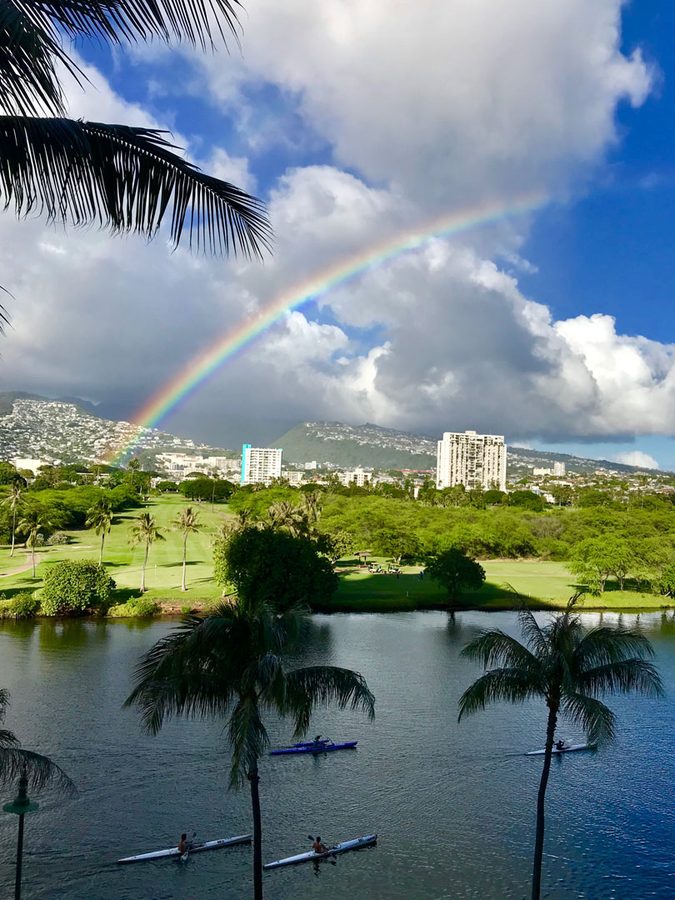 Rainbow over Honolulu golf course and kayakers on the Ala Wai canal